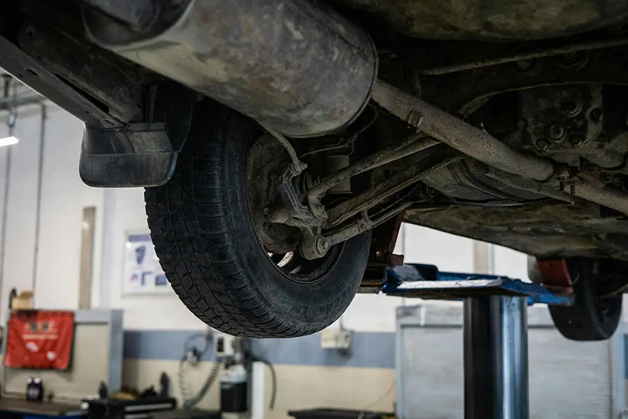 Technician performing wheel alignment service in Agoura Hills CA